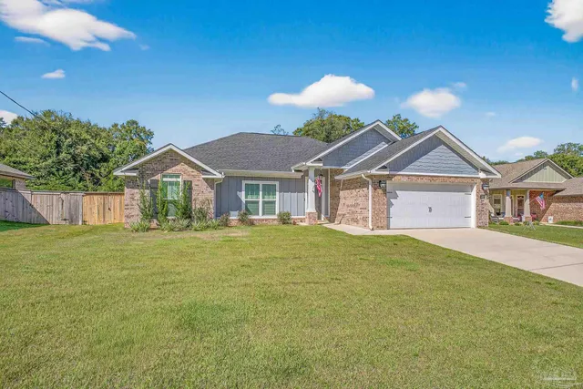 a front view of a house with a garden and patio