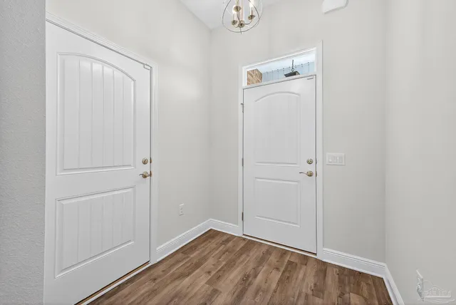 a view of a hallway with wooden floor and closet