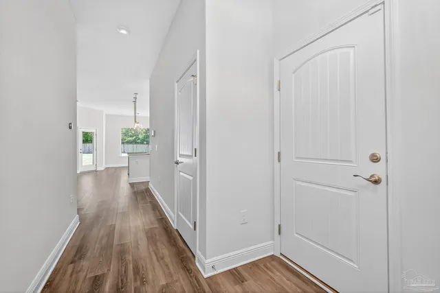 a view of a room with wooden floor and white walls
