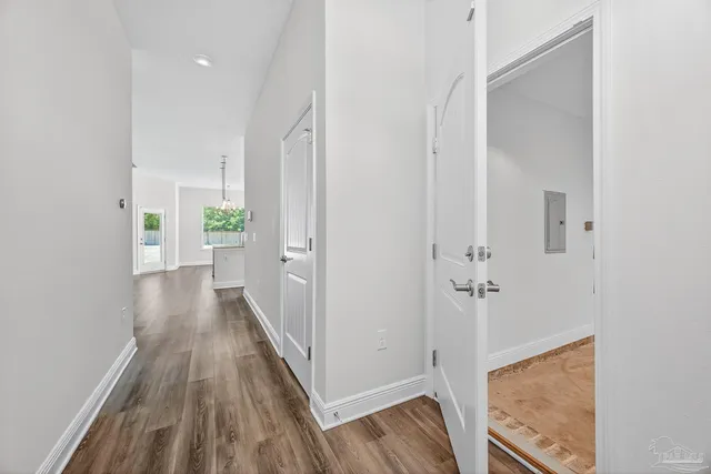 a view of a room with wooden floor and a bathroom