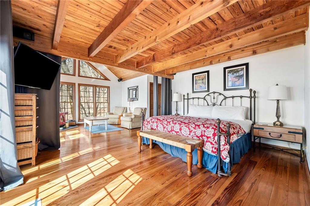 1474 Deer Run Ridge Jasper, GA 30143 - Photo 29 of 50 a bedroom with a bed and wooden floor