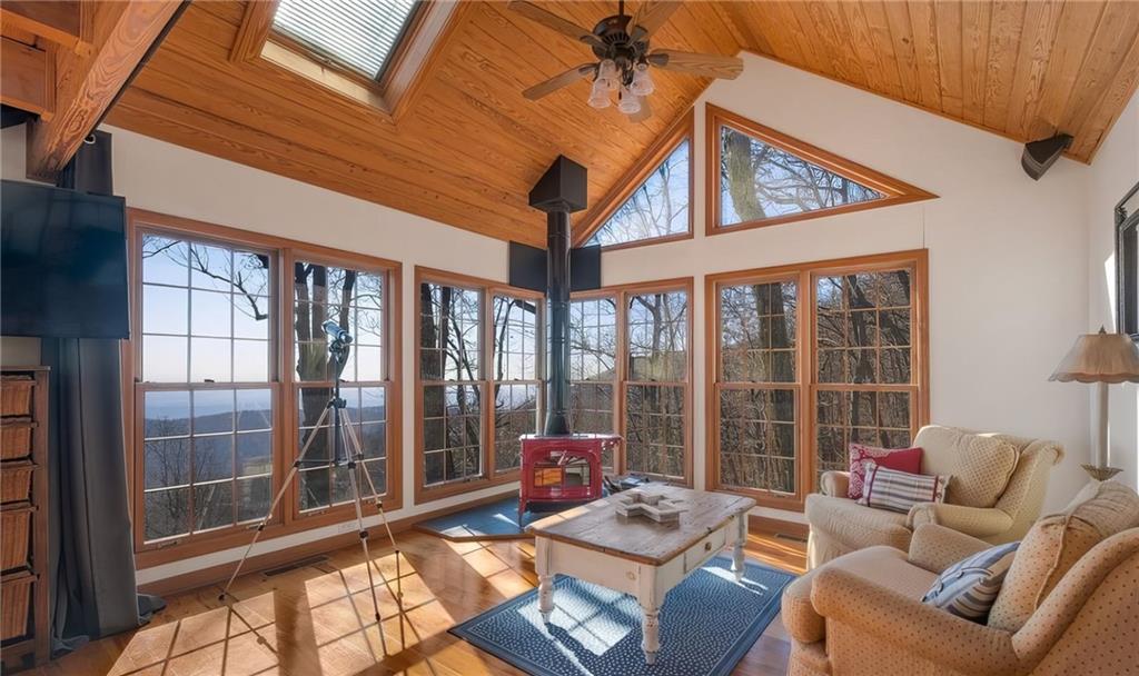 1474 Deer Run Ridge Jasper, GA 30143 - Photo 33 of 50 a living room with furniture and a floor to ceiling window