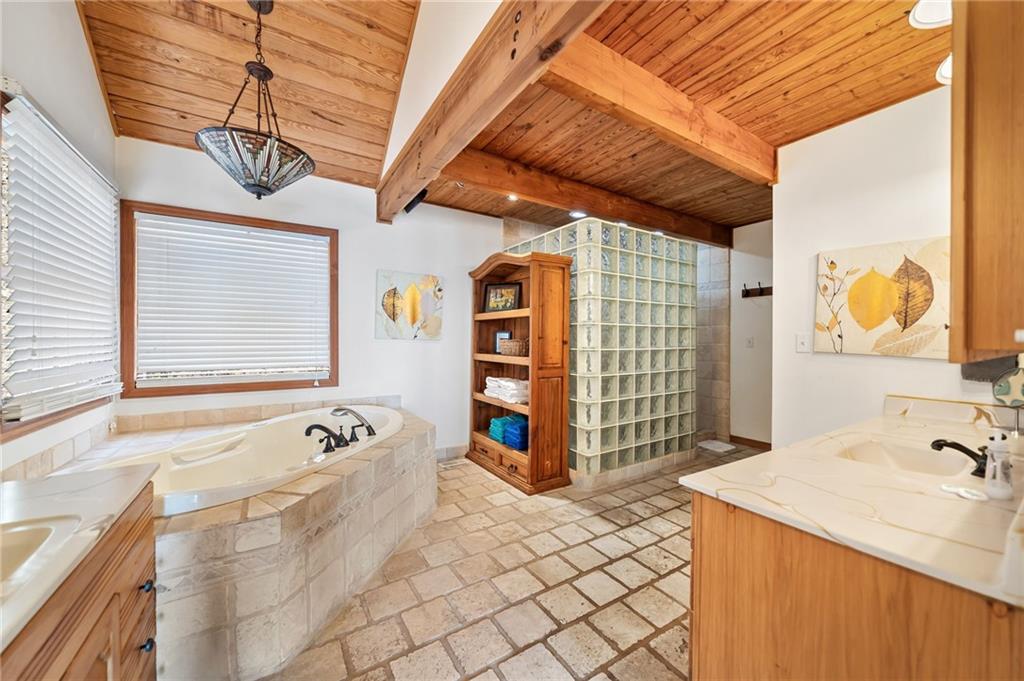 1474 Deer Run Ridge Jasper, GA 30143 - Photo 34 of 50 a bathroom with a tub sink and mirror