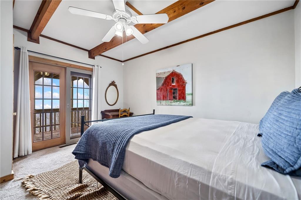 1474 Deer Run Ridge Jasper, GA 30143 - Photo 42 of 50 a bedroom with a bed and wooden floor