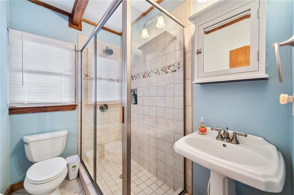 1474 Deer Run Ridge Jasper, GA 30143 - Photo 44 of 50 a bathroom with a sink a toilet and shower