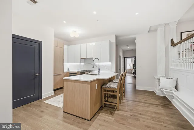 a kitchen that has a table and chairs in it