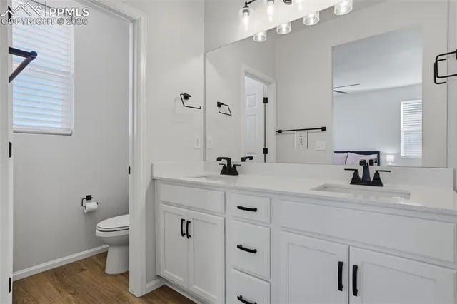 a en suite bathroom with a double vanity sink a mirror and a shower
