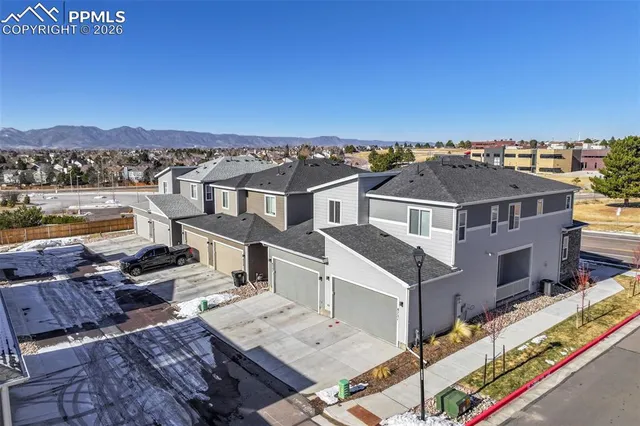 a kitchen with stainless steel appliances a dining table chairs stove refrigerator and cabinets