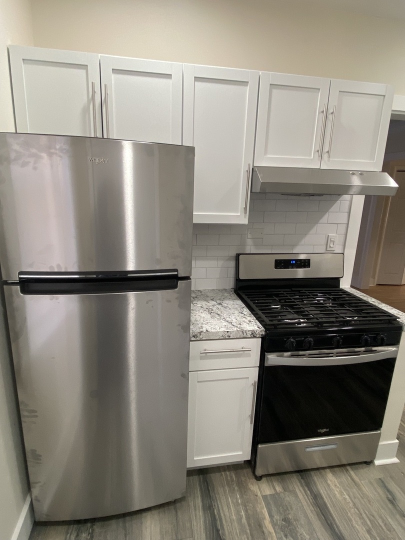 2210 East 70th Street, Unit 1 Chicago, IL 60649 - Photo 14 of 15 a stove top oven sitting inside of a kitchen
