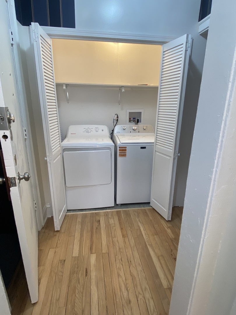 2210 East 70th Street, Unit 1 Chicago, IL 60649 - Photo 8 of 15 a storage room with wooden floor washer and dryer