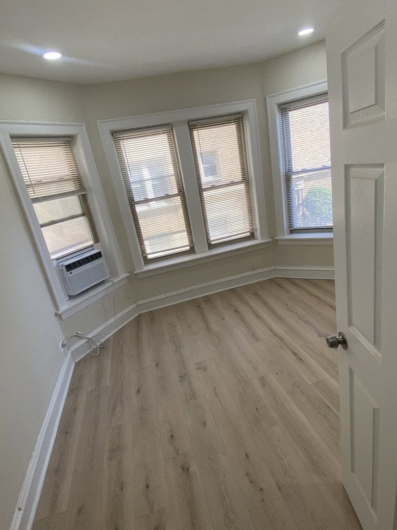 2210 East 70th Street, Unit 1 Chicago, IL 60649 - Photo 9 of 15 a view of an empty room with a window