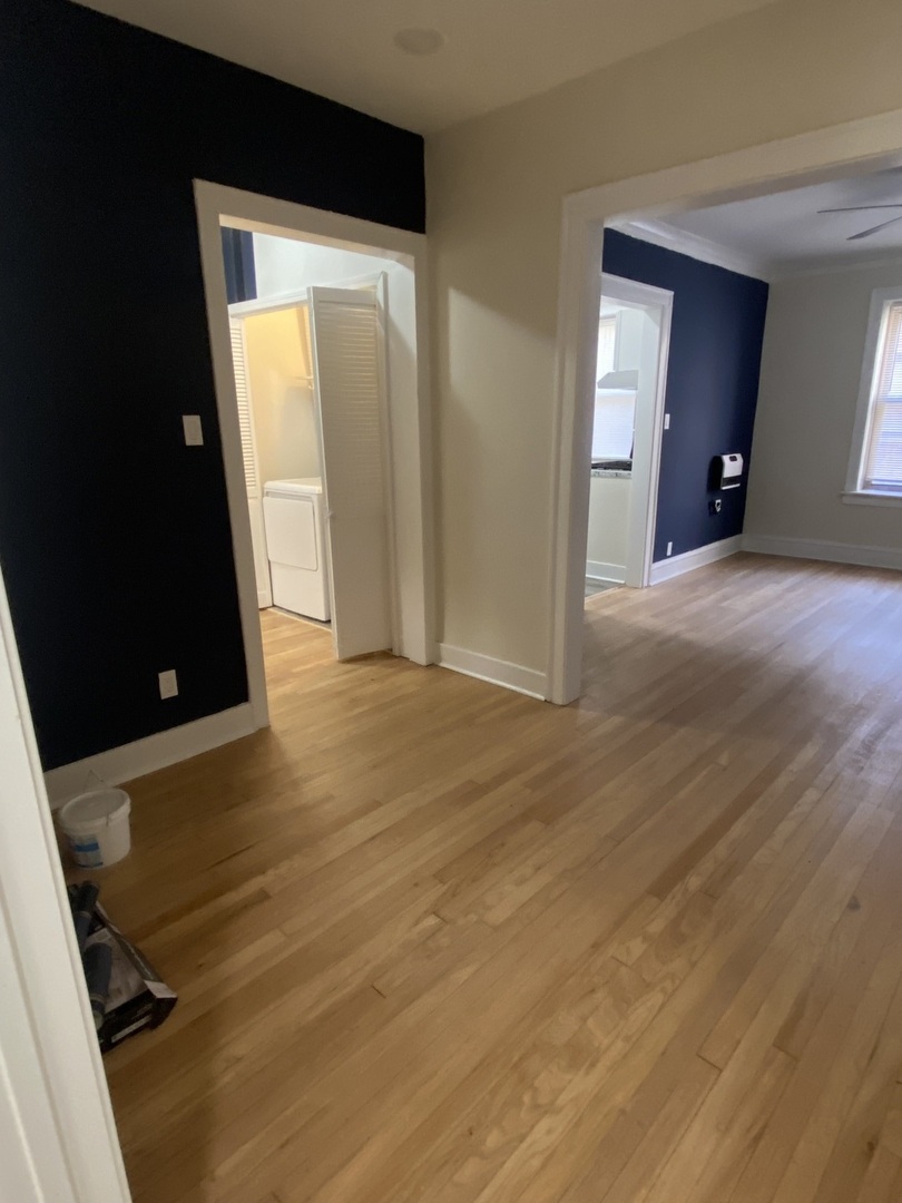 2210 East 70th Street, Unit 1 Chicago, IL 60649 - Photo 10 of 15 an empty room with wooden floor and closet