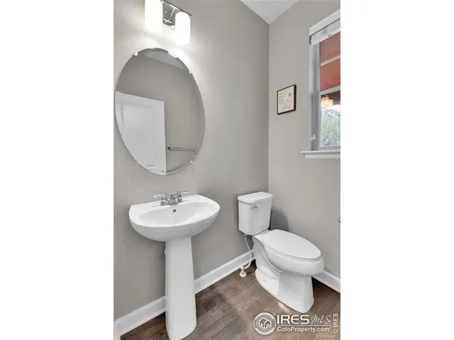 a bathroom with a sink toilet and a mirror
