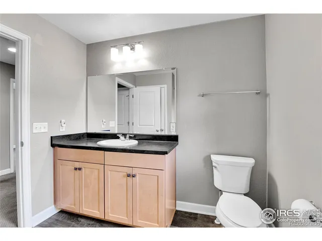 a bathroom with a toilet a sink and a mirror