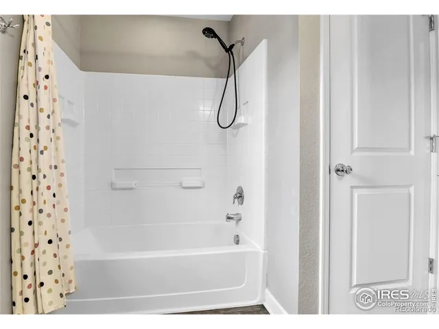 a bathroom with a bath tub and shower