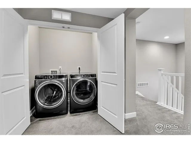 a utility room with sink dryer and washer