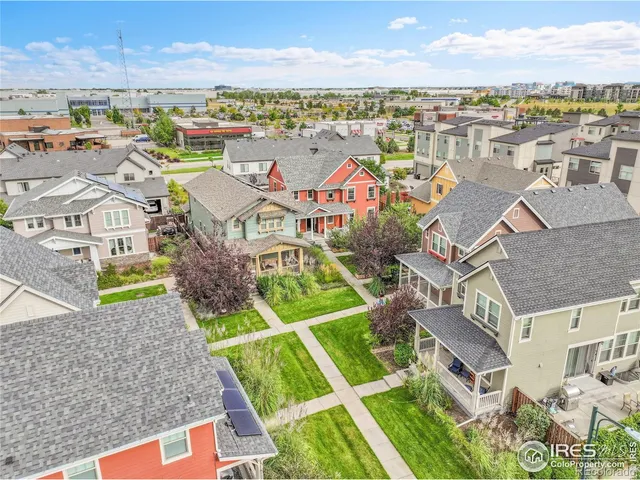 an aerial view of residential houses with outdoor space and ocean view