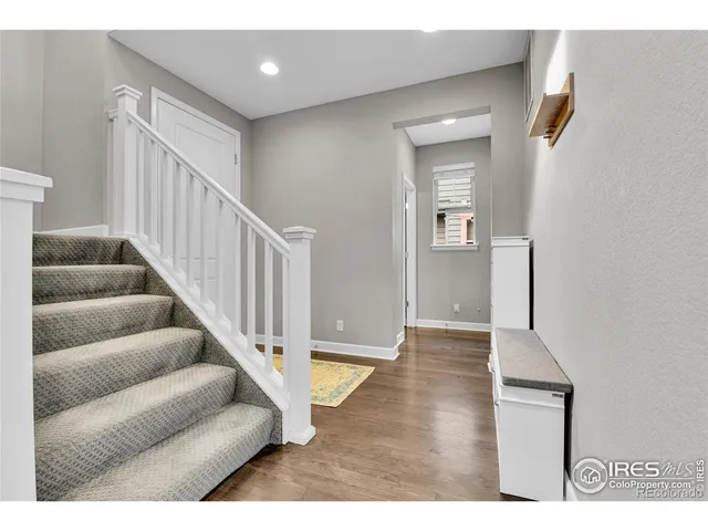 a view of entryway and hall with wooden floor