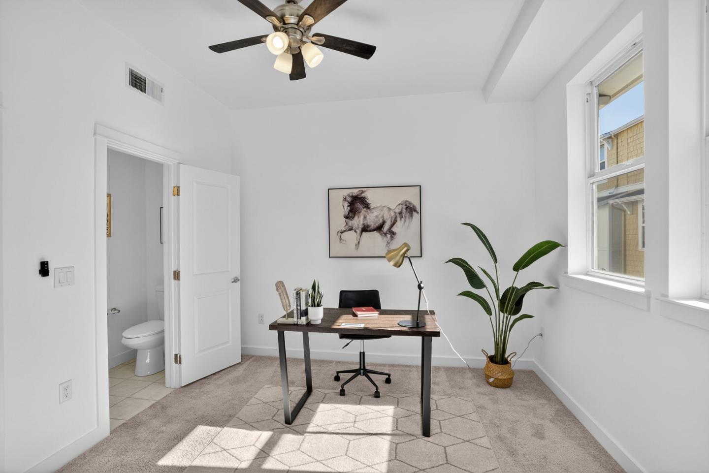 236 Grayson Terrace San Jose, CA 95126 - Photo 20 of 40 a workspace with white walls and a potted plant on th table