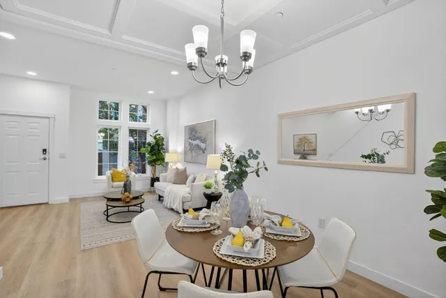 a view of a dining room with furniture wooden floor and chandelier