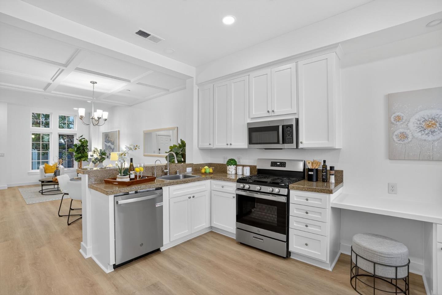 236 Grayson Terrace San Jose, CA 95126 - Photo 7 of 40 a kitchen with stainless steel appliances granite countertop a stove top oven a sink dishwasher and white cabinets with wooden floor