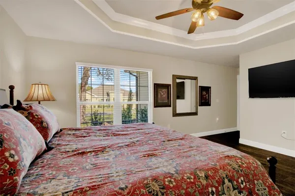 a bedroom with a large bed and a tv