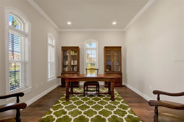 a view of a workspace with furniture and window
