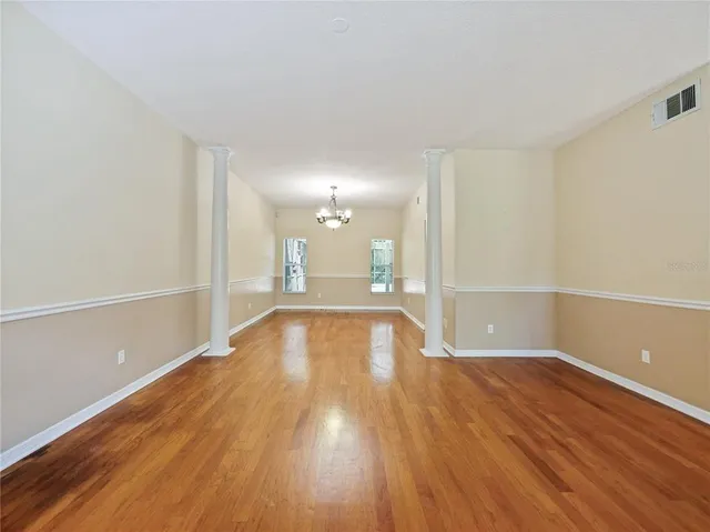 a view of a room with wooden floor and a window