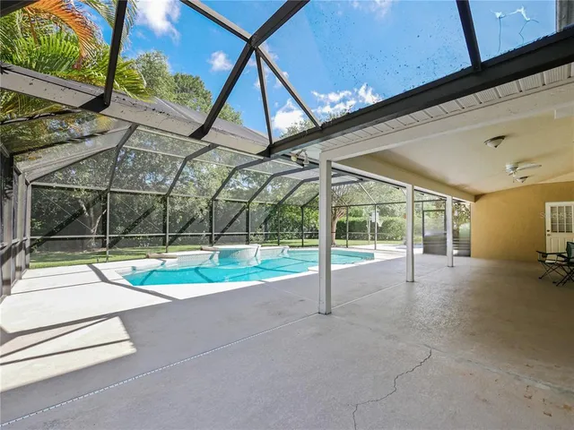 a view of an empty room with wooden floor and a floor to ceiling window