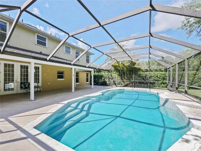 a view of a backyard with porch and a patio