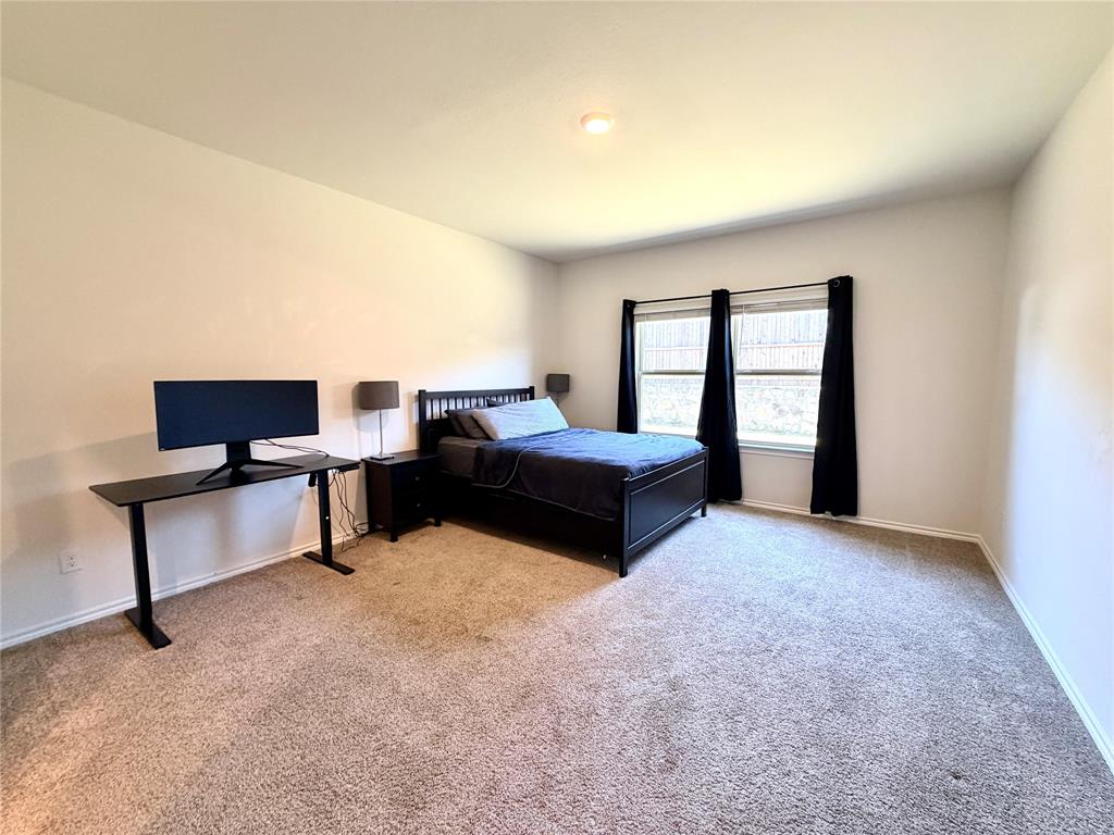 816 Country Road Royse City, TX 75189 - Photo 6 of 24 Carpeted room with neutral wall tones and a window featuring a fenced exterior