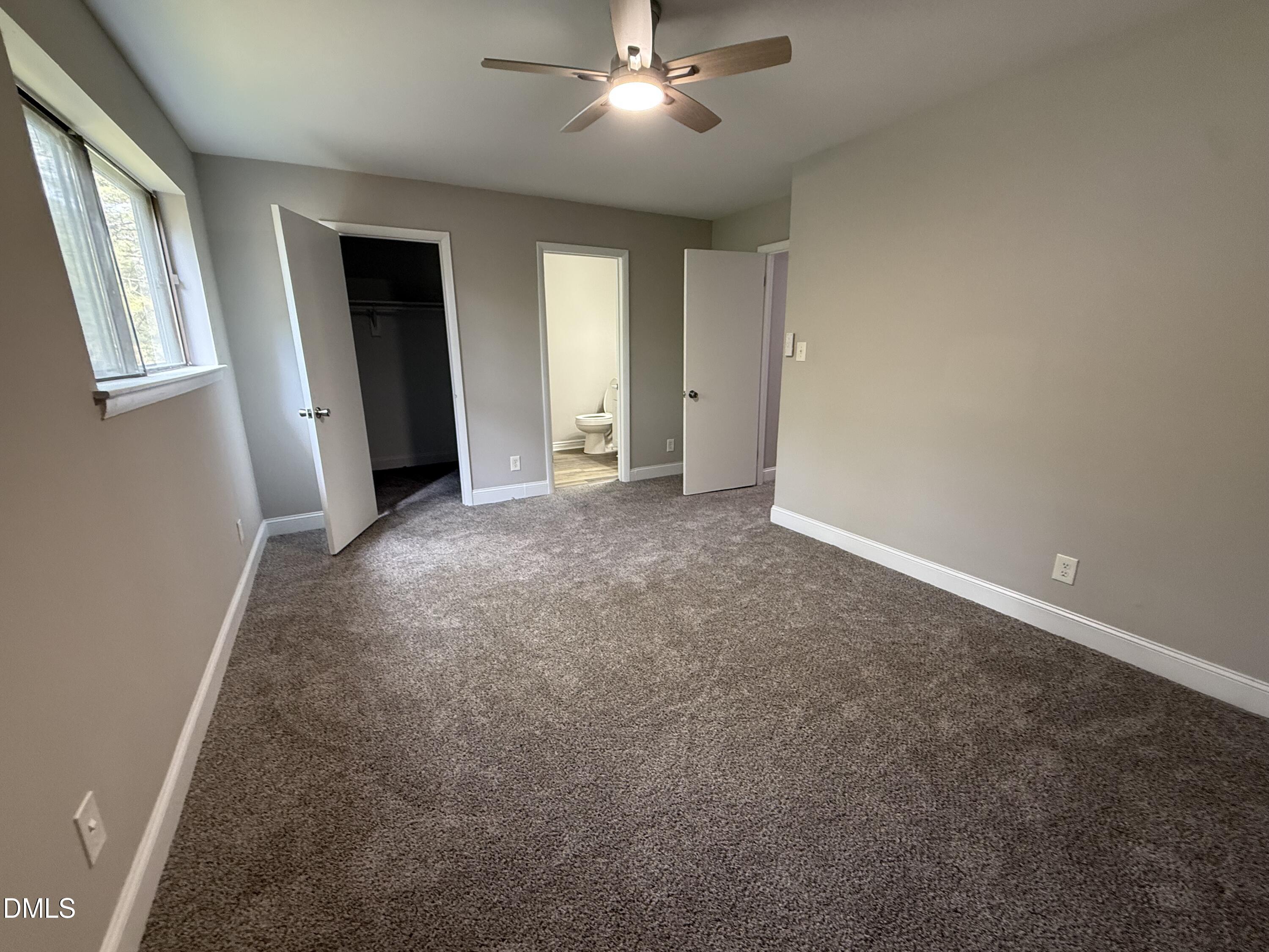 1114 Schaub Drive, Unit I Raleigh, NC 27606 - Photo 9 of 9 an empty room with closet and windows