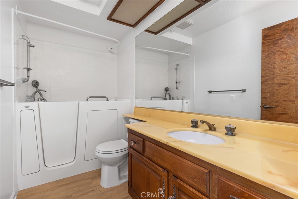 6200 Riviera Circle Long Beach, CA 90815 - Photo 23 of 35 a bathroom with a granite countertop toilet sink and mirror