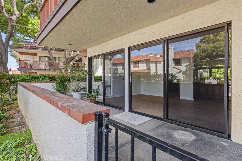 6200 Riviera Circle Long Beach, CA 90815 - Photo 26 of 35 a view of balcony with floor to ceiling window and wooden floor