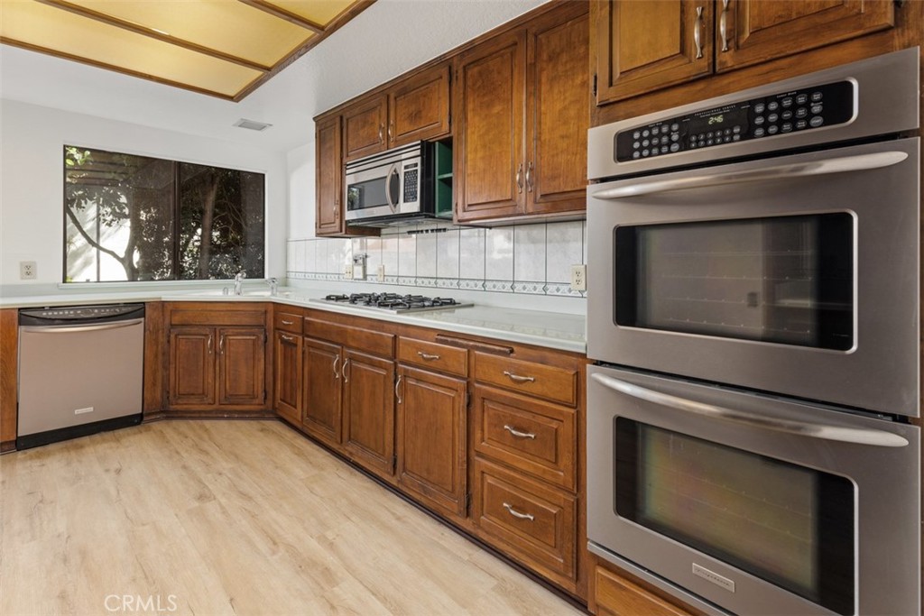 6200 Riviera Circle Long Beach, CA 90815 - Photo 9 of 35 a kitchen with stainless steel appliances granite countertop a stove microwave and sink
