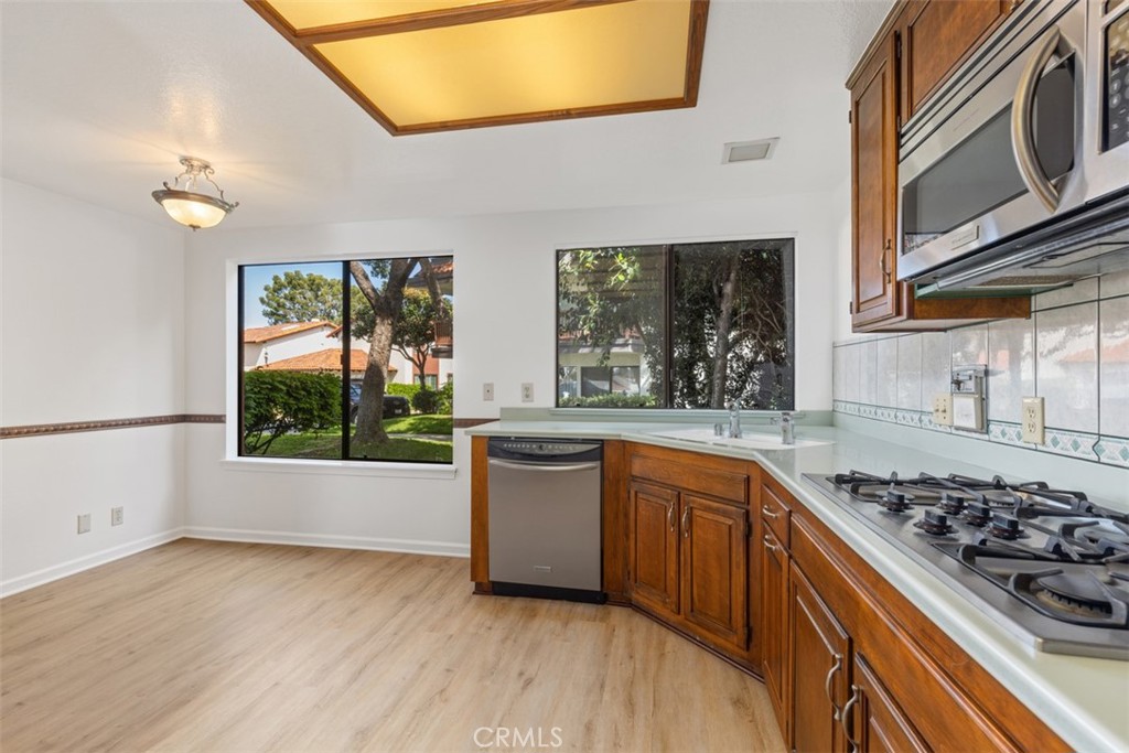 6200 Riviera Circle Long Beach, CA 90815 - Photo 10 of 35 a kitchen with stainless steel appliances a stove a sink and a microwave