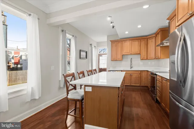 a kitchen with granite countertop a sink stove and refrigerator