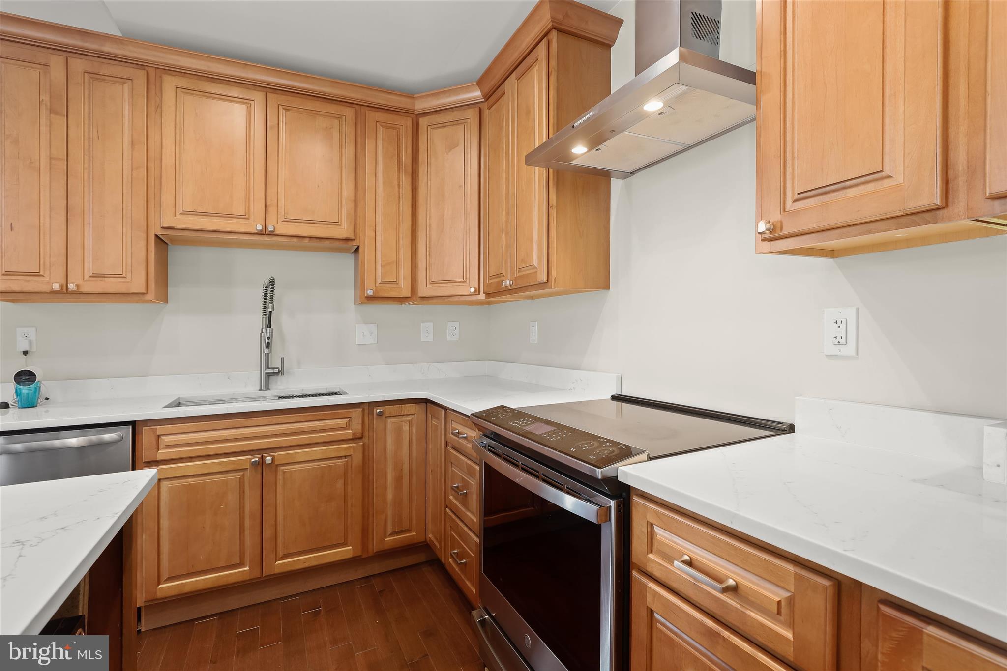 2820 East Baltimore Street Baltimore, MD 21224 - Photo 14 of 45 a kitchen with stainless steel appliances granite countertop a sink and cabinets with wooden floor