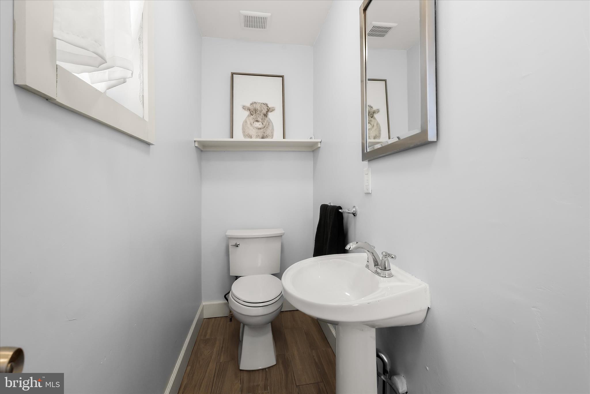 2820 East Baltimore Street Baltimore, MD 21224 - Photo 15 of 45 a bathroom with a toilet sink and mirror