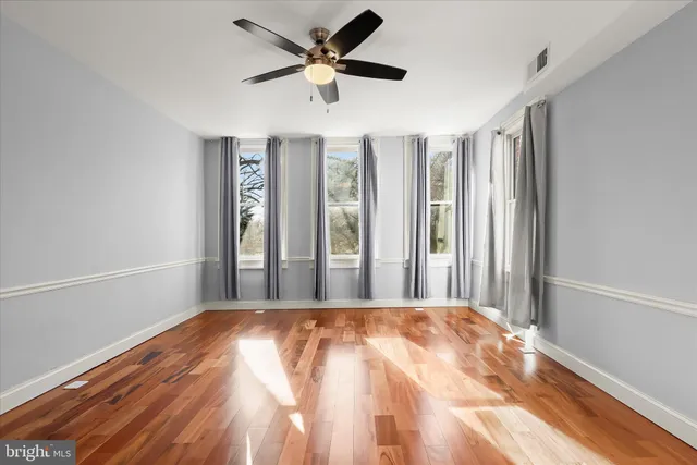 a view of a livingroom with a ceiling fan and window