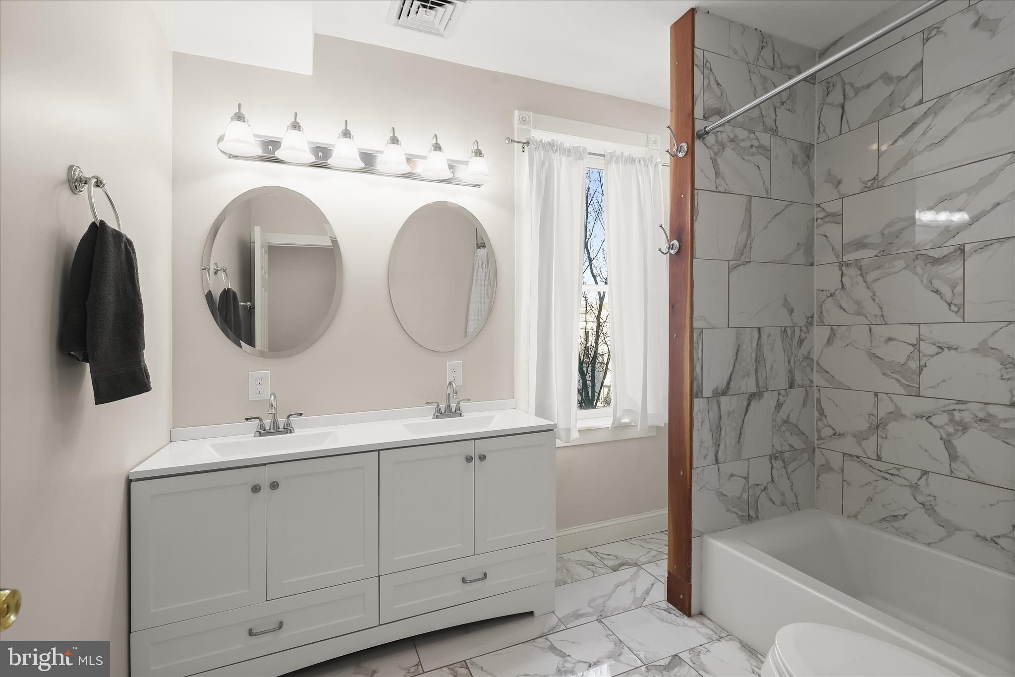 2820 East Baltimore Street Baltimore, MD 21224 - Photo 22 of 45 a bathroom with a double vanity sink mirror and bathtub