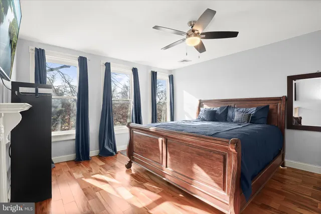 a bed sitting in a bedroom next to a window