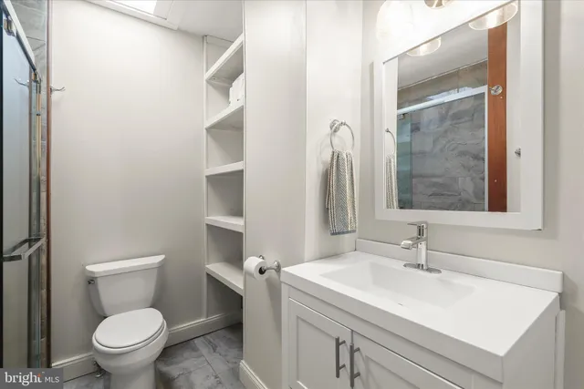 a bathroom with a sink toilet and vanity