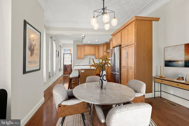 a view of a dining room with furniture and wooden floor
