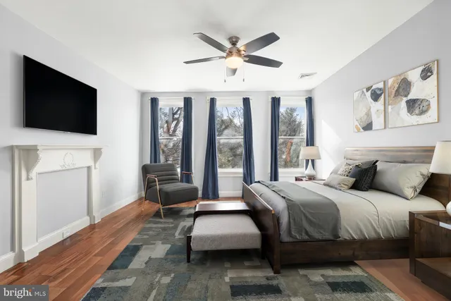 a bedroom with a bed and a large window