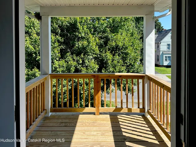 a view of a balcony with wooden floor