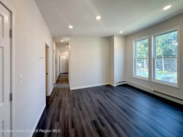 a view of a room with wooden floor and window