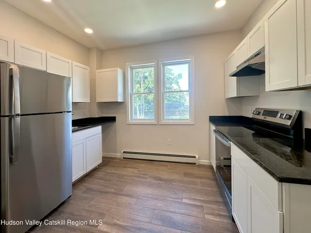 a kitchen with a refrigerator sink and microwave