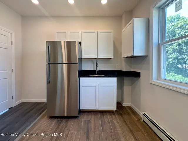 a kitchen with a refrigerator and a sink