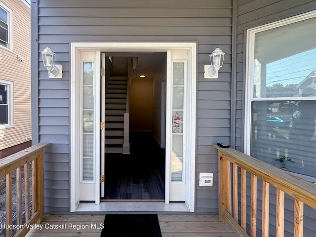 a view of a balcony with a door and wooden floor